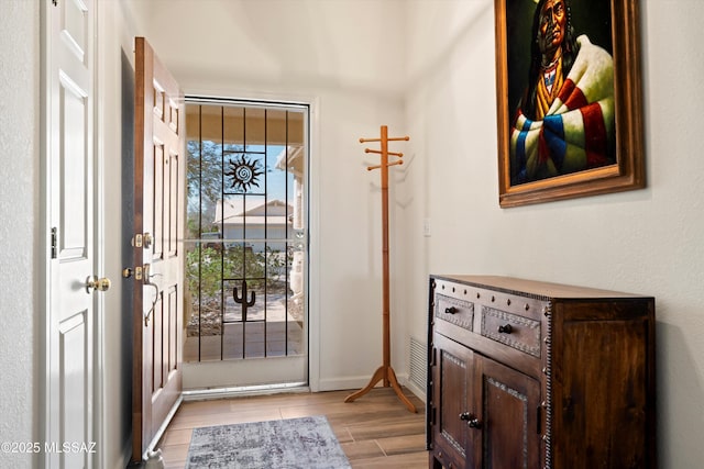 entrance foyer with wood finish floors and baseboards