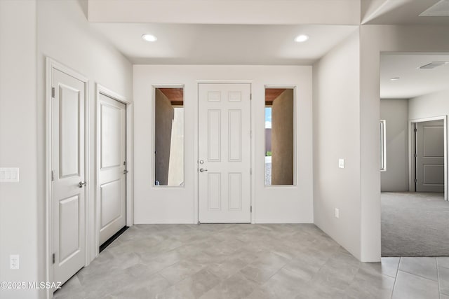 interior space with light colored carpet, recessed lighting, and visible vents