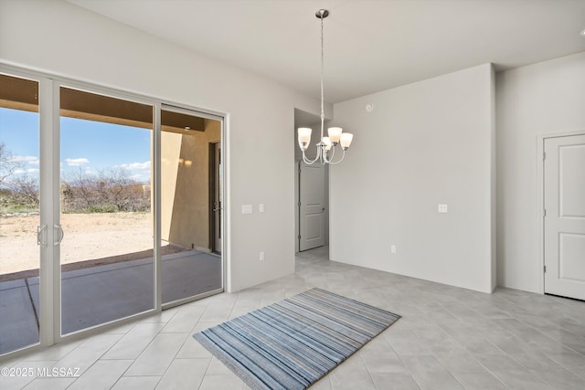 empty room featuring light tile patterned floors and a chandelier