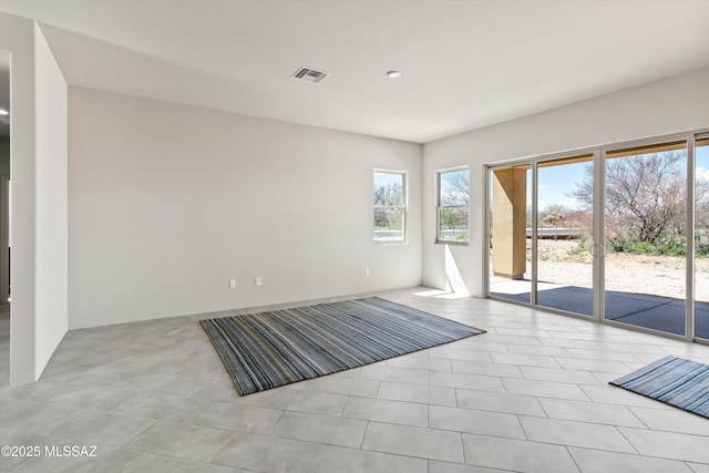 spare room featuring visible vents and plenty of natural light