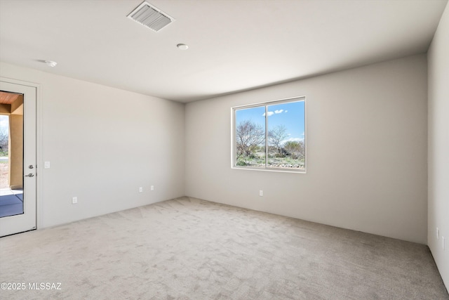 unfurnished room featuring visible vents and carpet floors