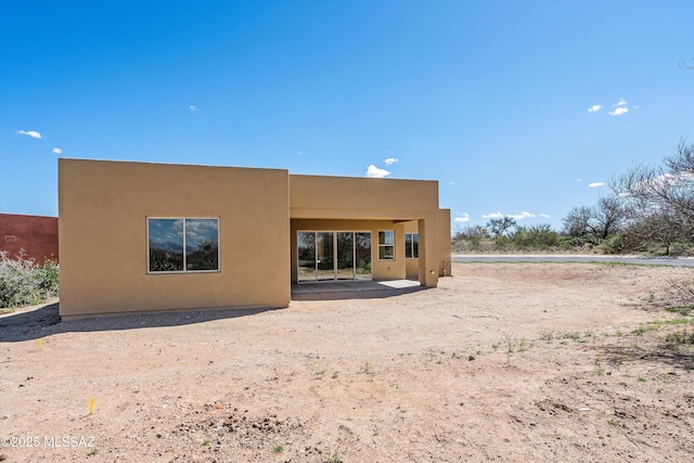 back of property featuring a patio and stucco siding