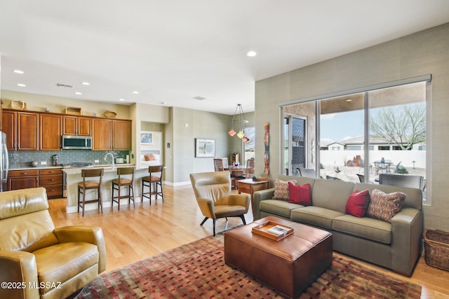 living room with light hardwood / wood-style flooring