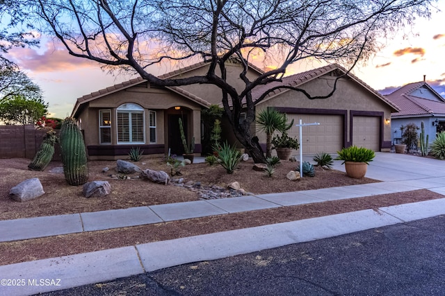 5481 W Cochie Springs St, Marana, AZ 85658 - view of front facade with concrete driveway, stucco siding, an attached garage, and a tile roof