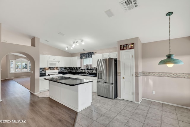 5481 W Cochie Springs St, Marana, AZ 85658 - kitchen with white cabinets, white appliances, visible vents, and vaulted ceiling
