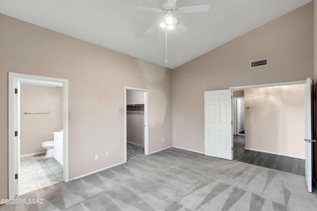 5481 W Cochie Springs St, Marana, AZ 85658 - unfurnished bedroom with visible vents, a spacious closet, high vaulted ceiling, and carpet floors