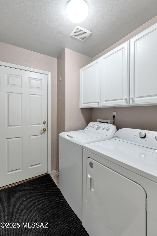 5481 W Cochie Springs St, Marana, AZ 85658 - laundry room featuring cabinet space, visible vents, and washing machine and clothes dryer