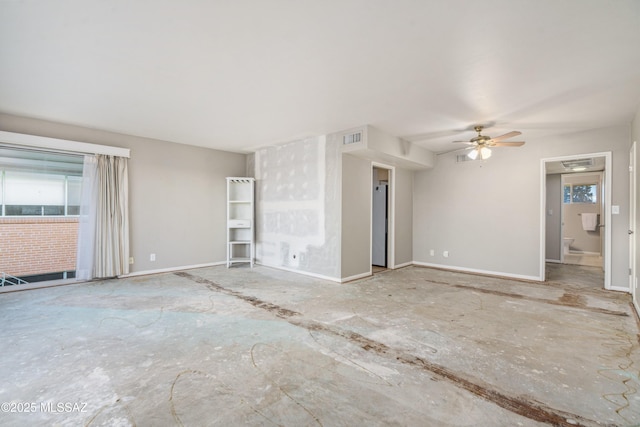 spare room featuring visible vents, ceiling fan, and baseboards