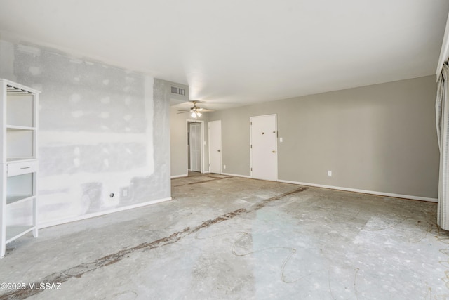 unfurnished room with a ceiling fan, unfinished concrete flooring, visible vents, and baseboards