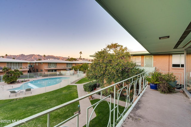 community pool featuring fence and a mountain view