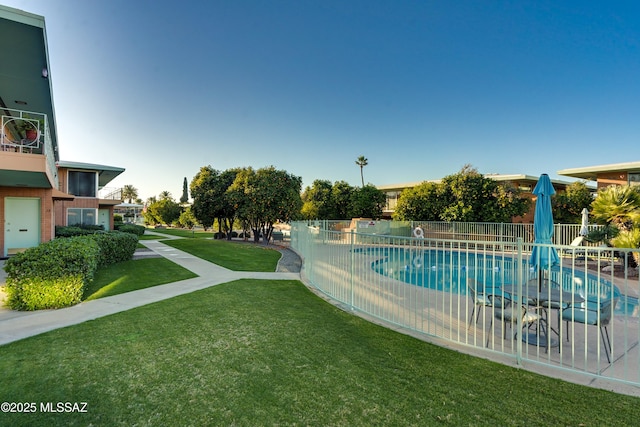 view of pool featuring a fenced in pool, a yard, and fence