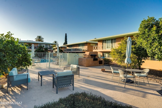 view of community featuring a patio and fence