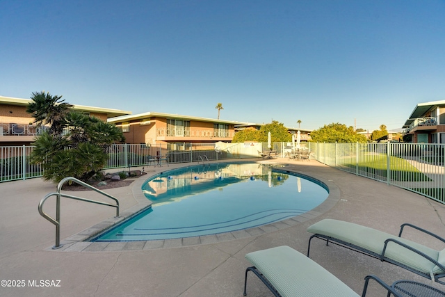 view of pool featuring a patio area, fence, and a fenced in pool