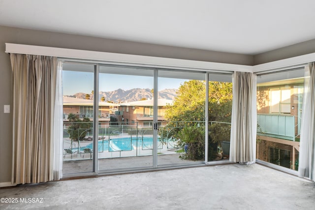 doorway to outside with concrete floors and a mountain view