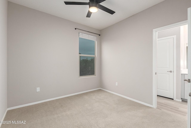 carpeted empty room featuring ceiling fan