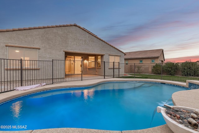 view of pool at dusk