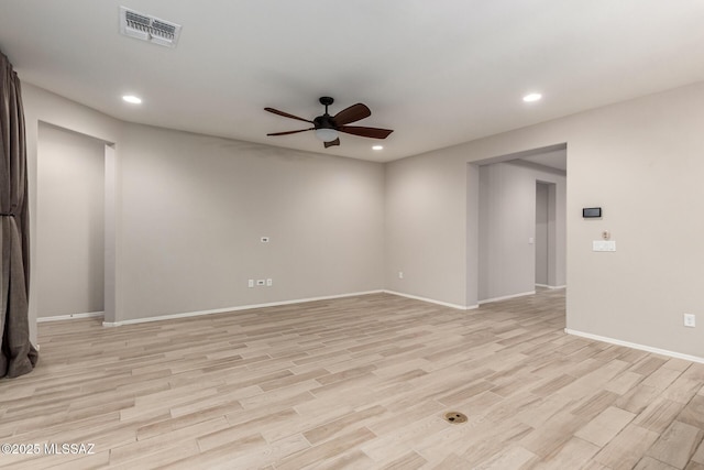 empty room with ceiling fan and light hardwood / wood-style floors