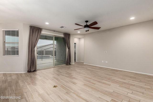 empty room featuring ceiling fan and light wood-type flooring