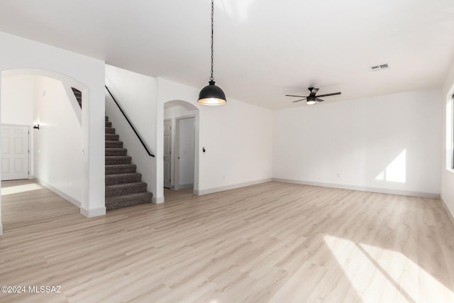 unfurnished living room featuring light hardwood / wood-style flooring and ceiling fan