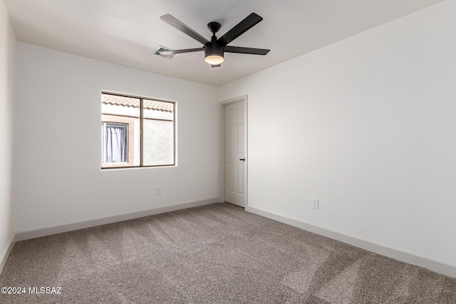 empty room with ceiling fan and carpet floors