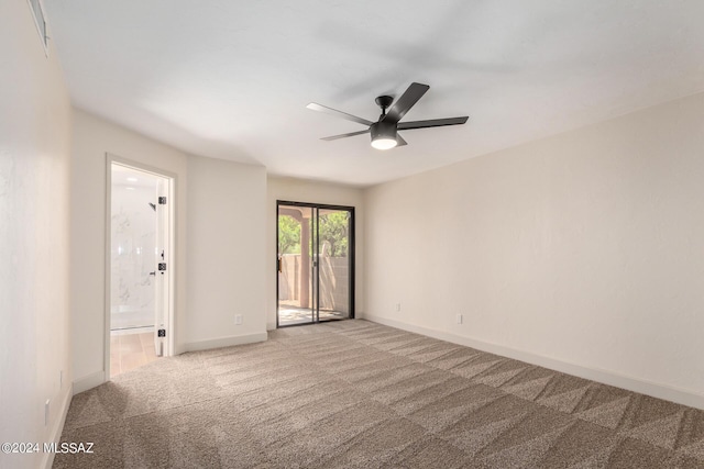 carpeted spare room featuring ceiling fan