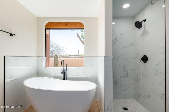 bathroom with independent shower and bath and tile walls