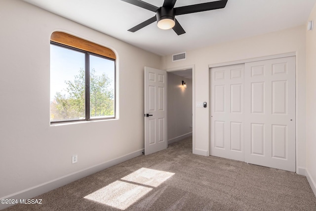 unfurnished bedroom featuring a closet, ceiling fan, and carpet flooring