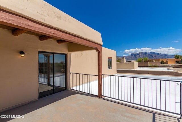 view of patio / terrace with a mountain view and a balcony