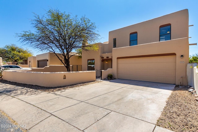 pueblo-style home with a garage