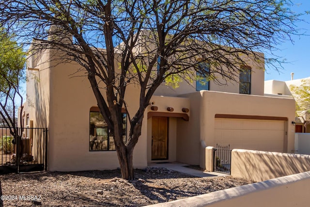 pueblo-style house with a garage