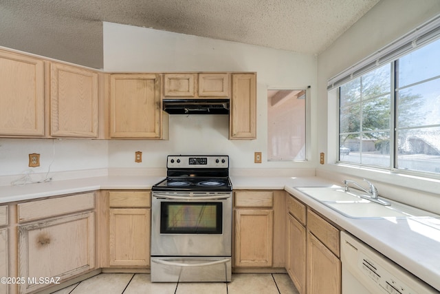 kitchen featuring sink, vaulted ceiling, light brown cabinets, electric range, and dishwasher