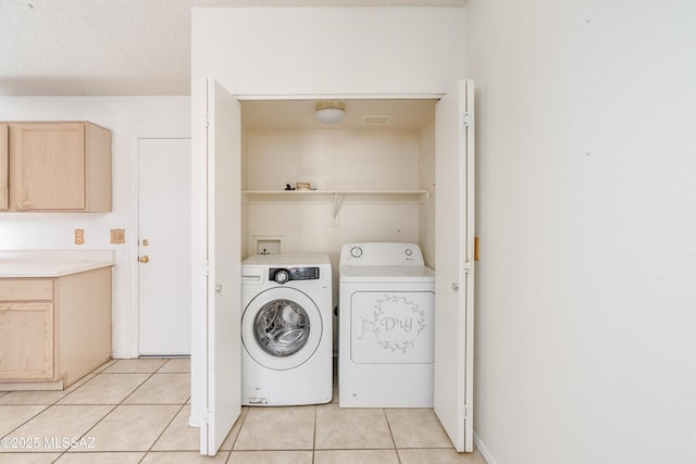 washroom featuring washer and dryer and light tile patterned floors