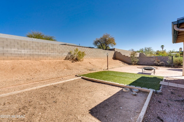 view of yard featuring an outdoor fire pit and a patio area