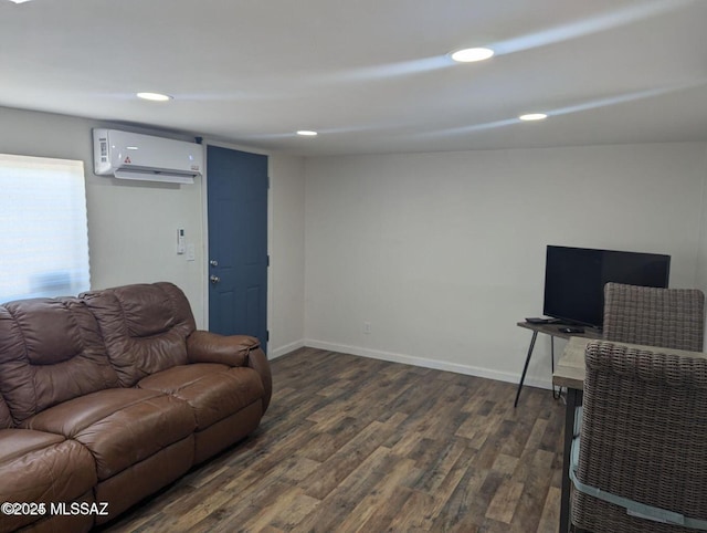 living room with dark wood-style floors, recessed lighting, a wall unit AC, and baseboards