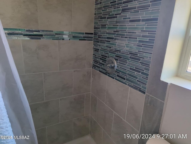 bathroom with a tile shower