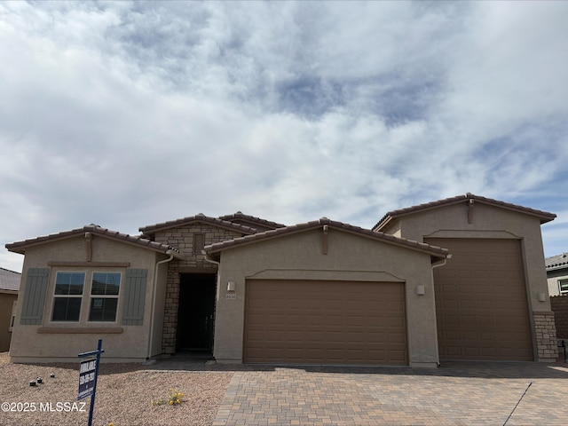 6650 W Winding Knoll Pl, Marana, AZ 85658 - view of front of property featuring a garage, concrete driveway, stucco siding, and a tiled roof