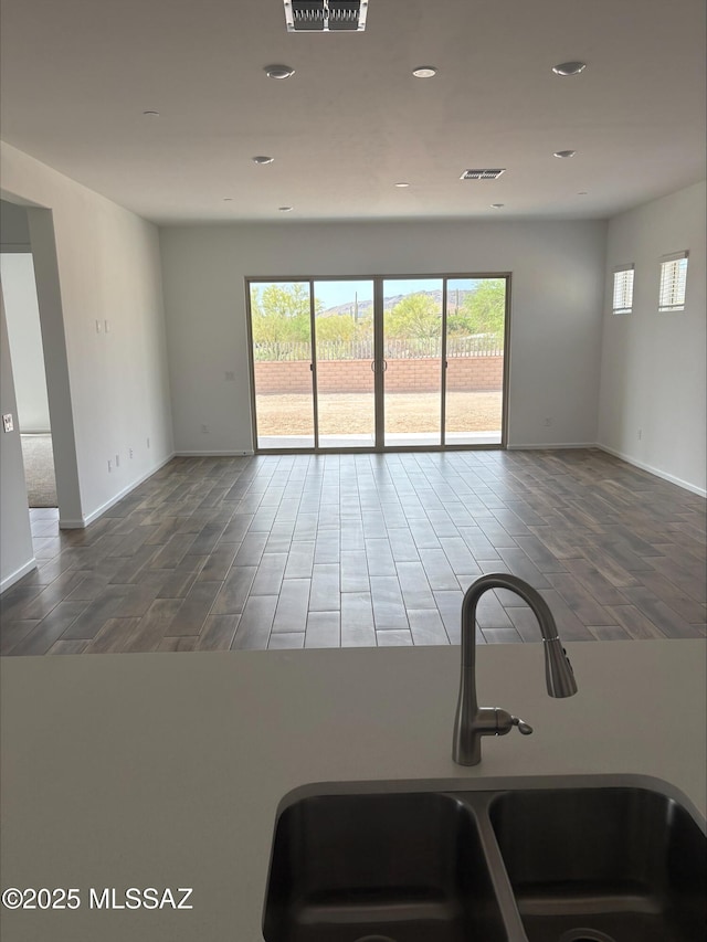 6650 W Winding Knoll Pl, Marana, AZ 85658 - unfurnished room with wood finished floors, a healthy amount of sunlight, and a sink