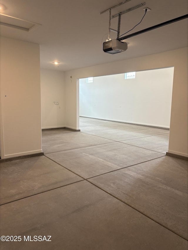 6650 W Winding Knoll Pl, Marana, AZ 85658 - garage featuring baseboards and a garage door opener