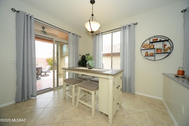 dining area with light tile patterned flooring and a healthy amount of sunlight