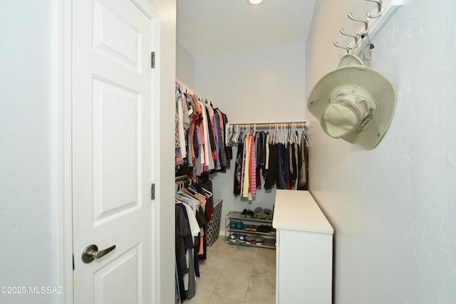 walk in closet featuring light tile patterned flooring