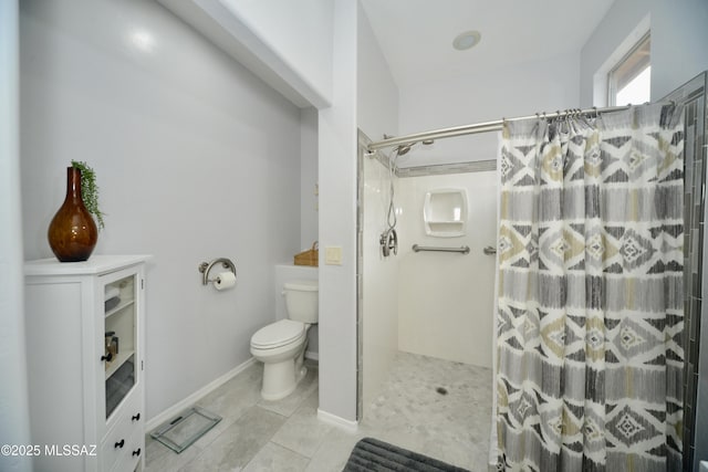 bathroom featuring a shower with curtain, tile patterned floors, and toilet