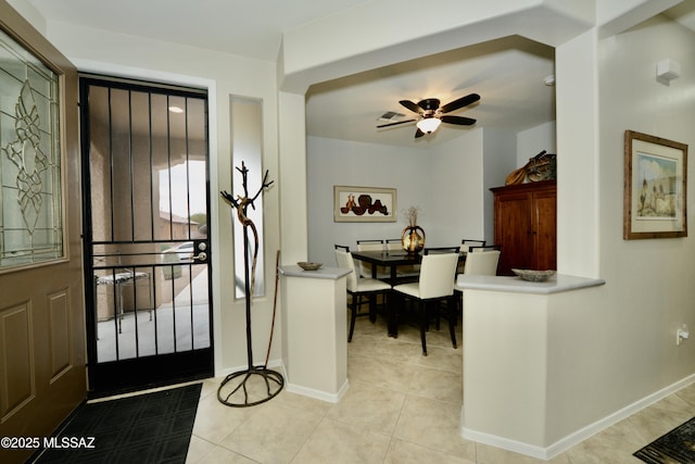 tiled dining area featuring ceiling fan