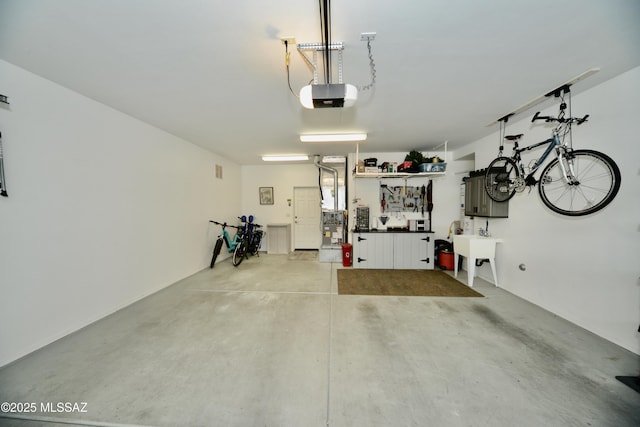 garage with a garage door opener and sink