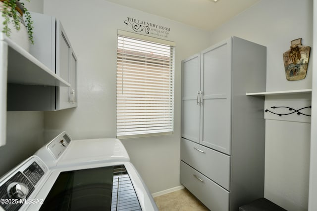 washroom featuring cabinets, separate washer and dryer, and light tile patterned floors