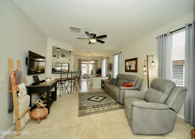 tiled living room featuring ceiling fan