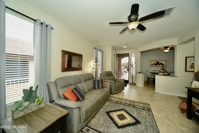 living room with ceiling fan and light tile patterned floors