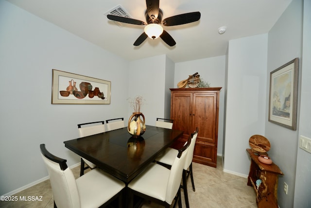 dining space featuring ceiling fan and light tile patterned flooring