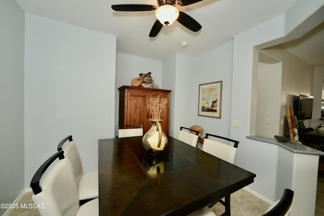 tiled dining area featuring ceiling fan