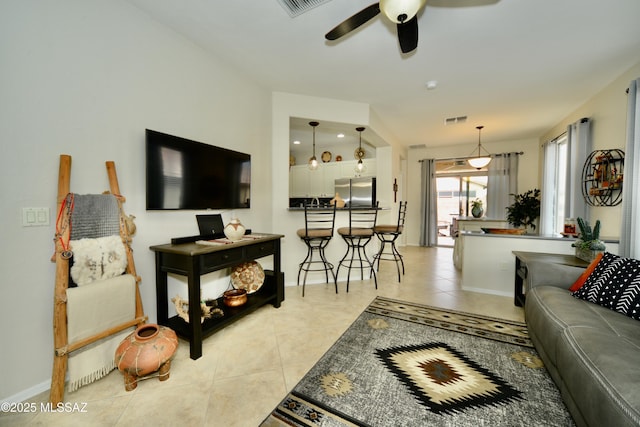 living room featuring light tile patterned floors and ceiling fan