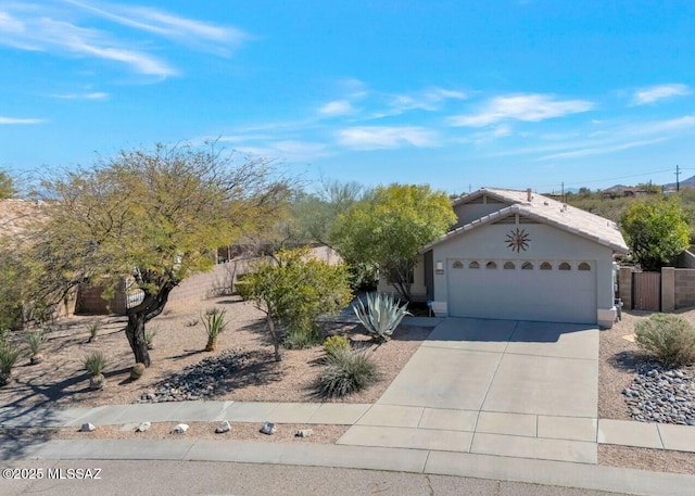 view of front of property featuring concrete driveway, an attached garage, a tiled roof, and stucco siding